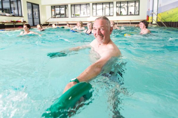 Die Kursteilnehmer machen Übungen mit Gewichten in den Händen.